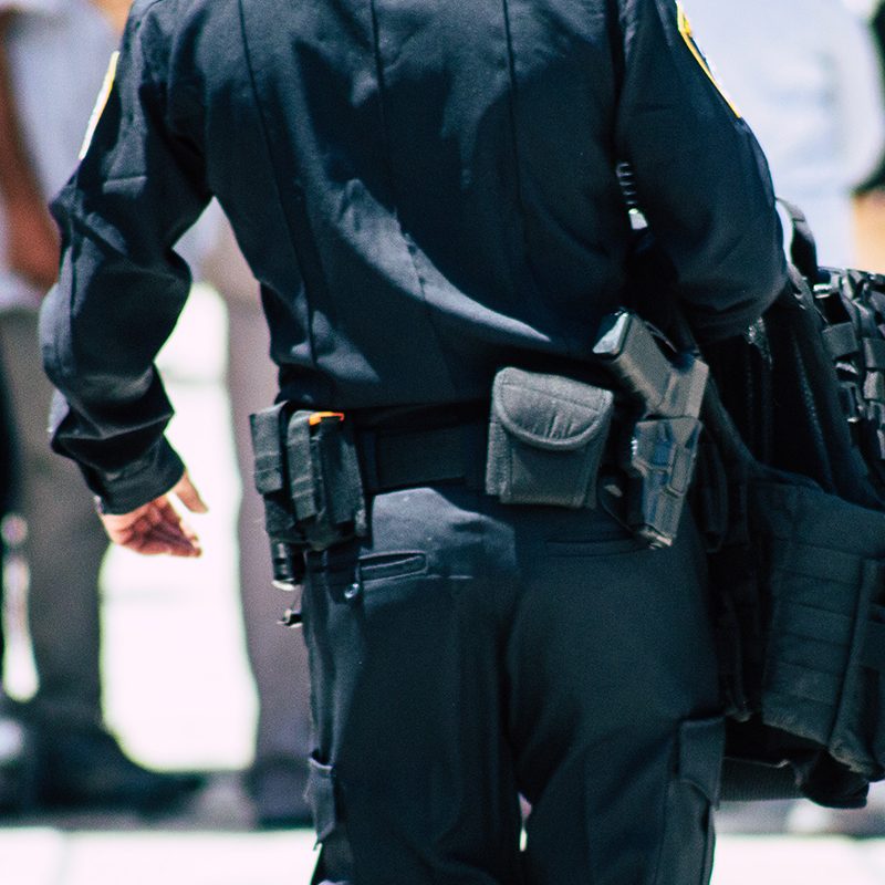 cropped image of police officer walking away